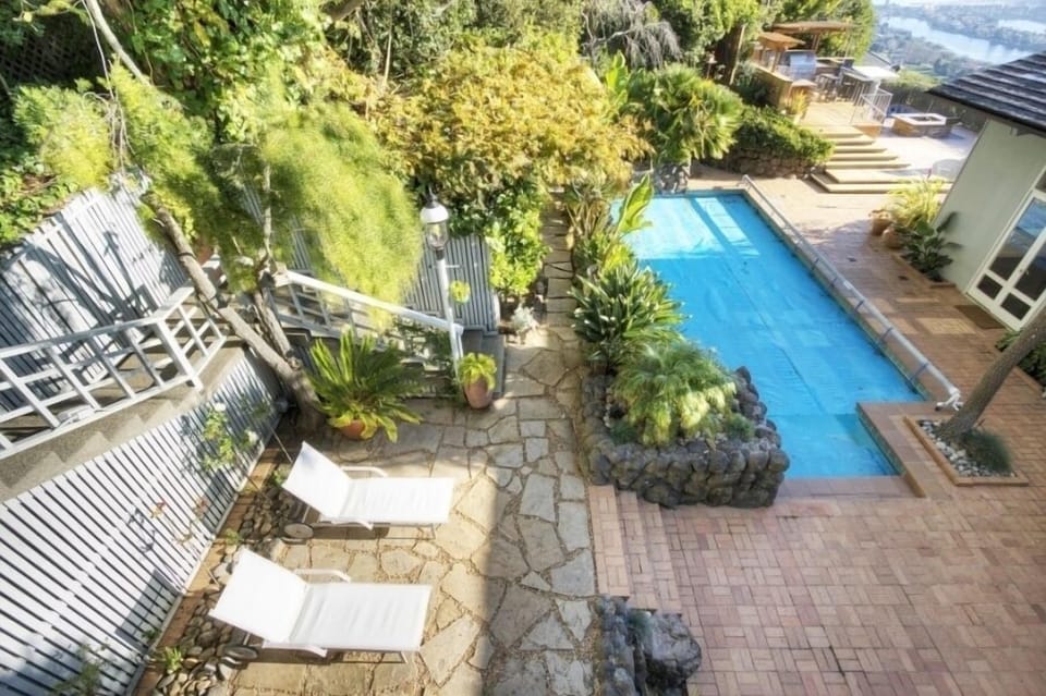 View of swimming pool, outdoor kitchen area and SF Bay from upstairs bedroom.