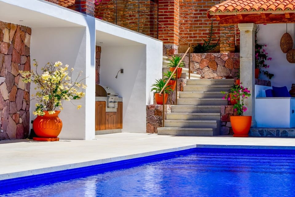 Outdoor kitchen with BBQ, sink and refrigerator