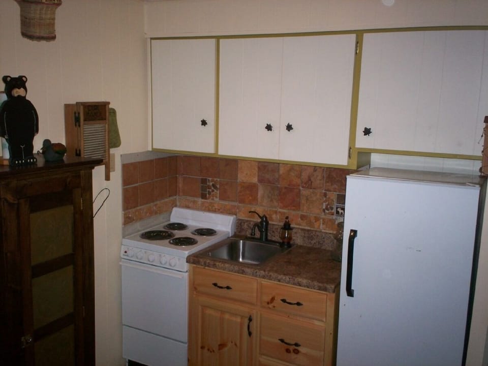 Remodelled Kitchen also has small microwave and table.