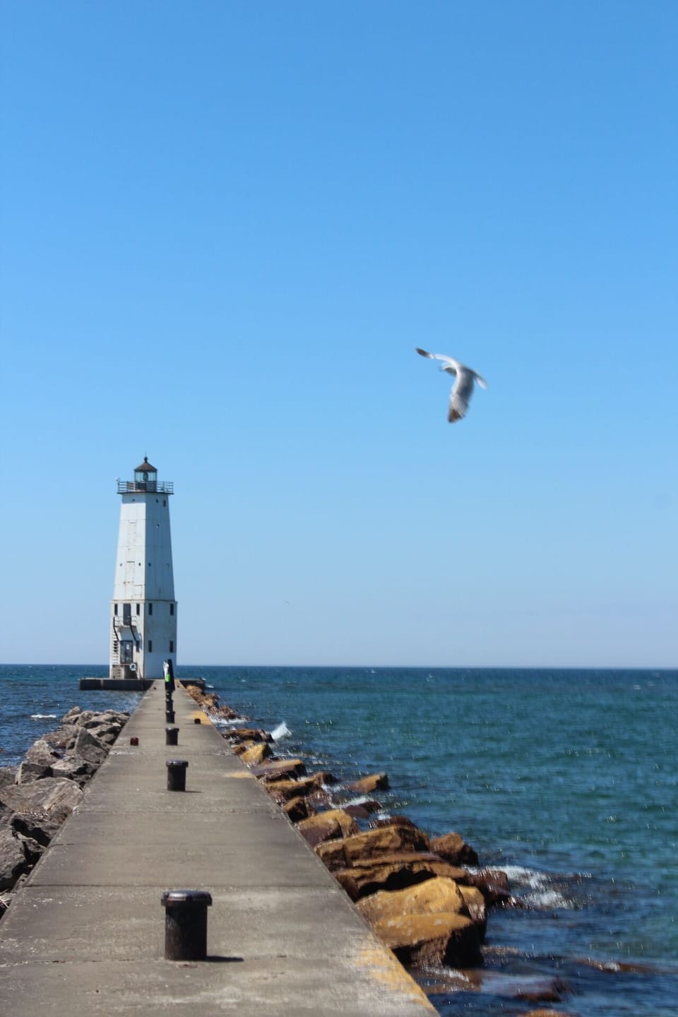 Frankfort lighthouse on Betsy Bay and the walkable pier.