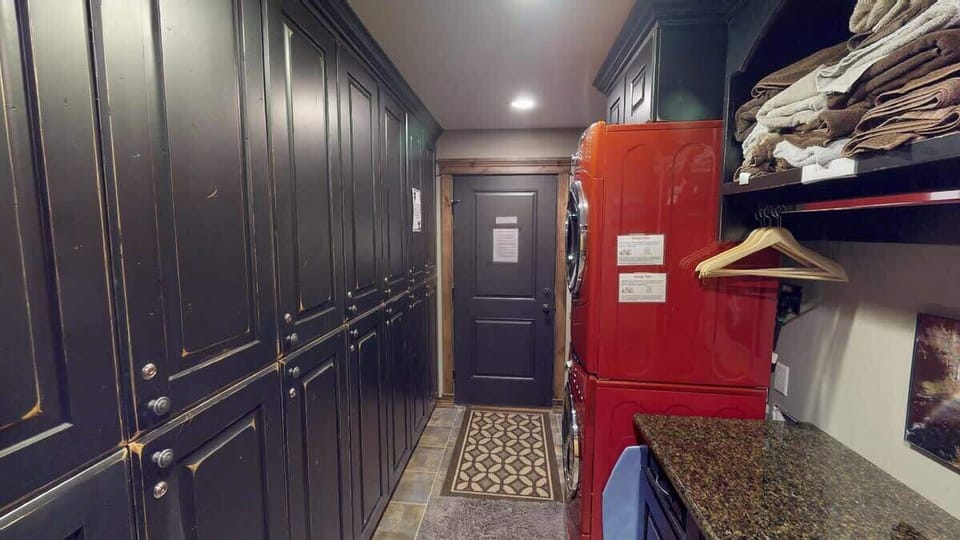Mud room with full size stacked washer and dryer.