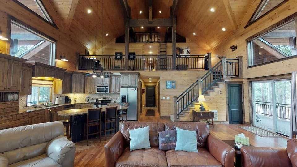 The open kitchen blends seamlessly into the cabin's cozy living area, creating a welcoming space perfect for gathering and unwinding.