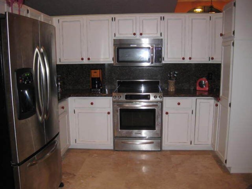 The kitchen has granite & stainless steel appliances