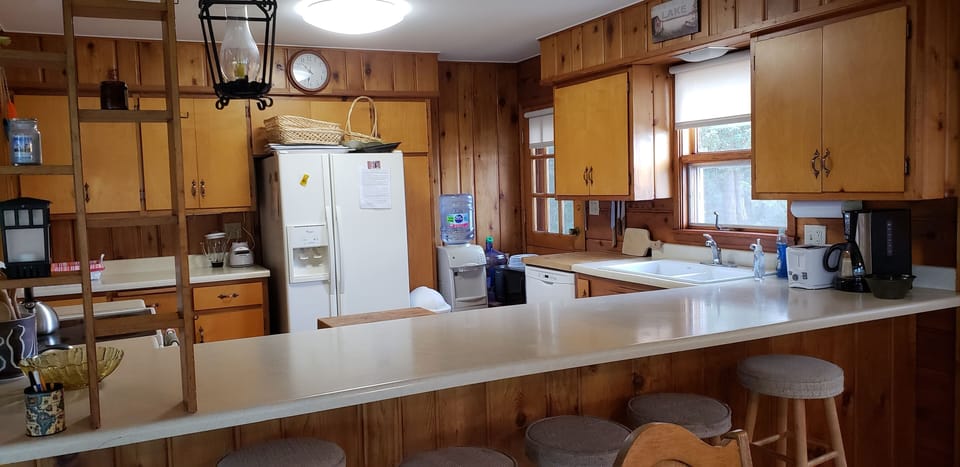 Kitchen with bar stools at the counter; open to Dining Area