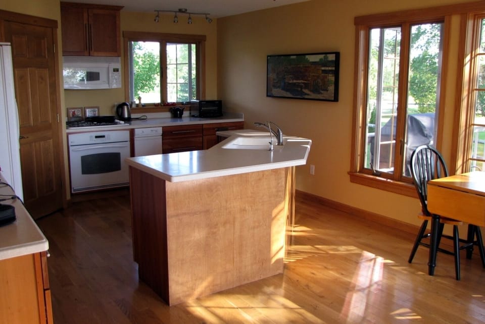 Spacious and light kitchen with small dining area.