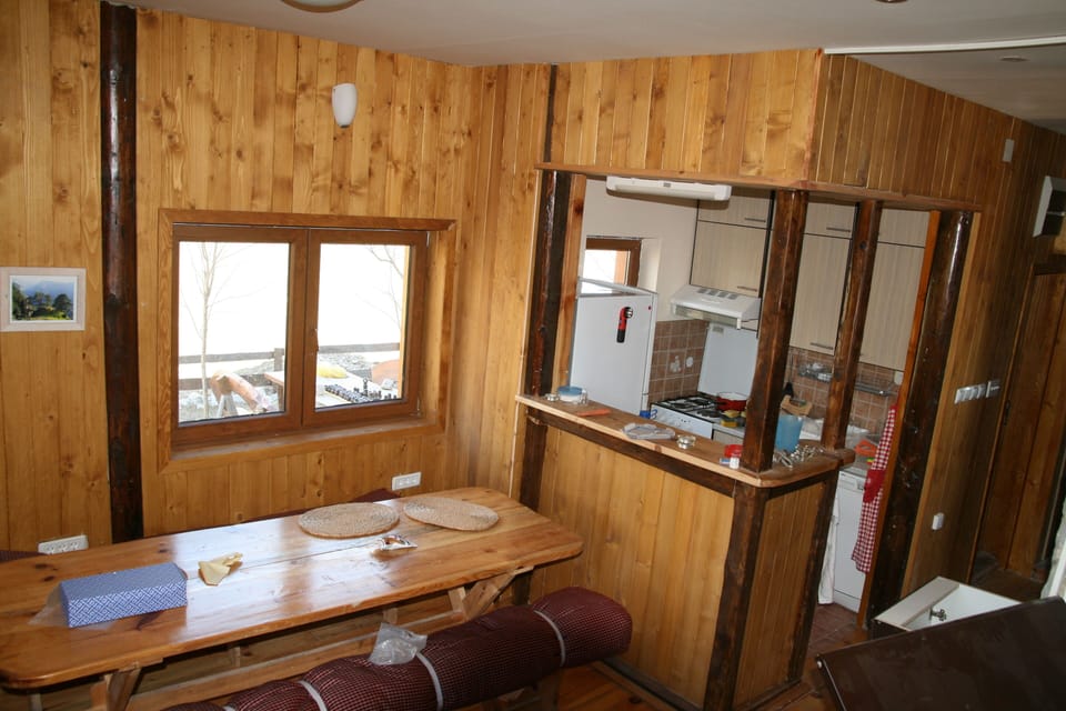 Dining table and kitchen with mountain views