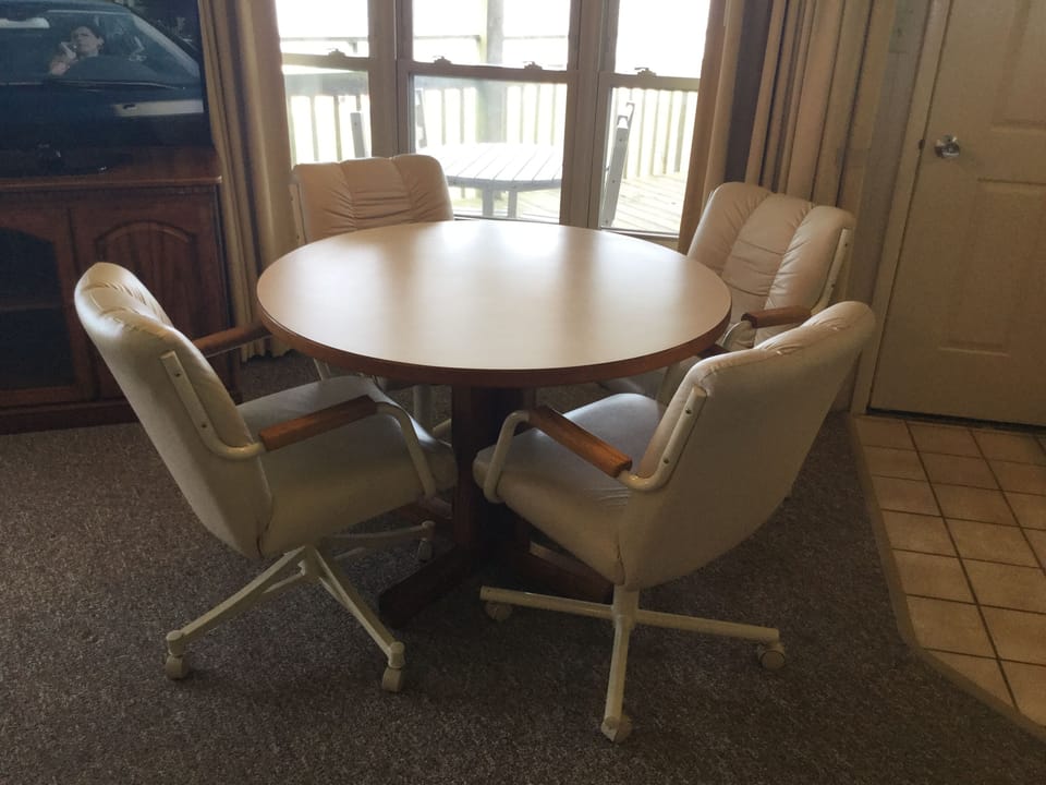 Round Table with Four Chairs in Living Room Area
