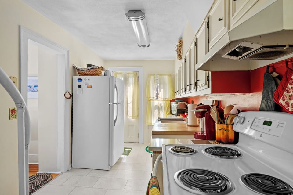 Kitchen with view of door and fridge
