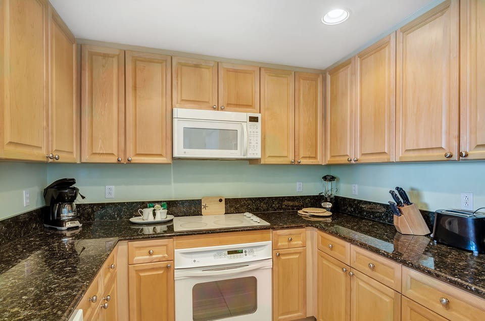 Kitchen with all pot/pans and appliances.