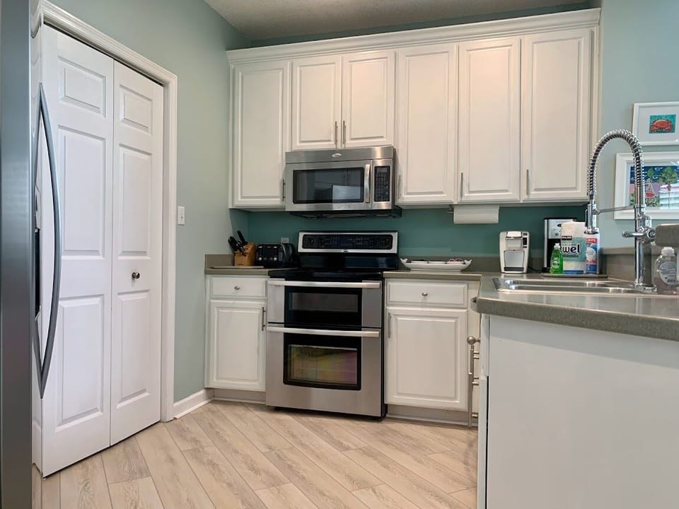 Kitchen and closet door to washer and dryer.  Keurig and regular coffee pot. 