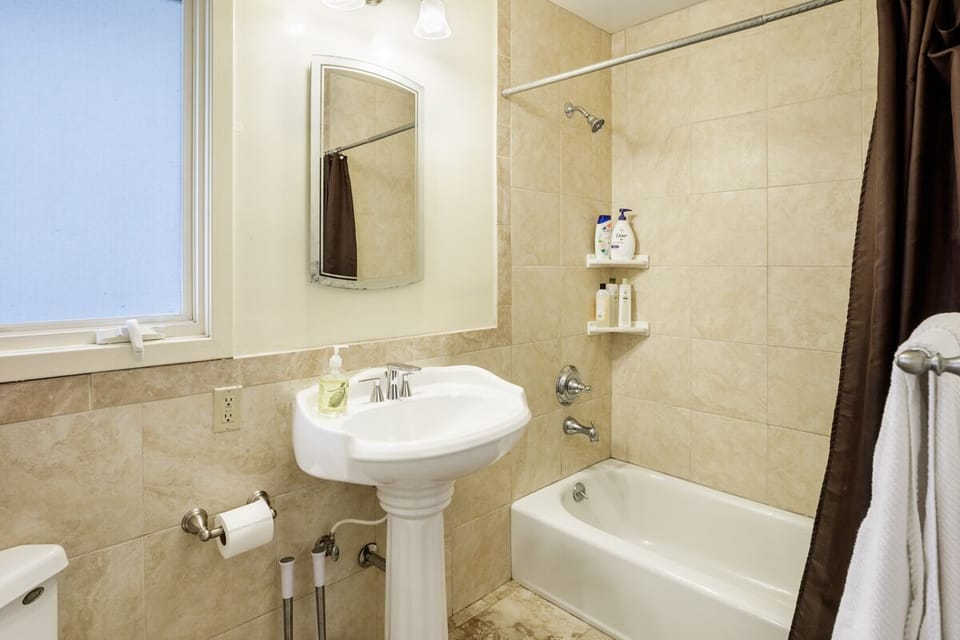Guest Bathroom with shower over tub.