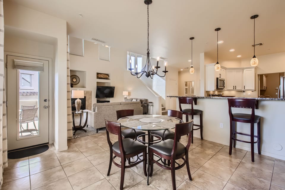 Dining room, living room, kitchen and side door out to patio & electric grill.