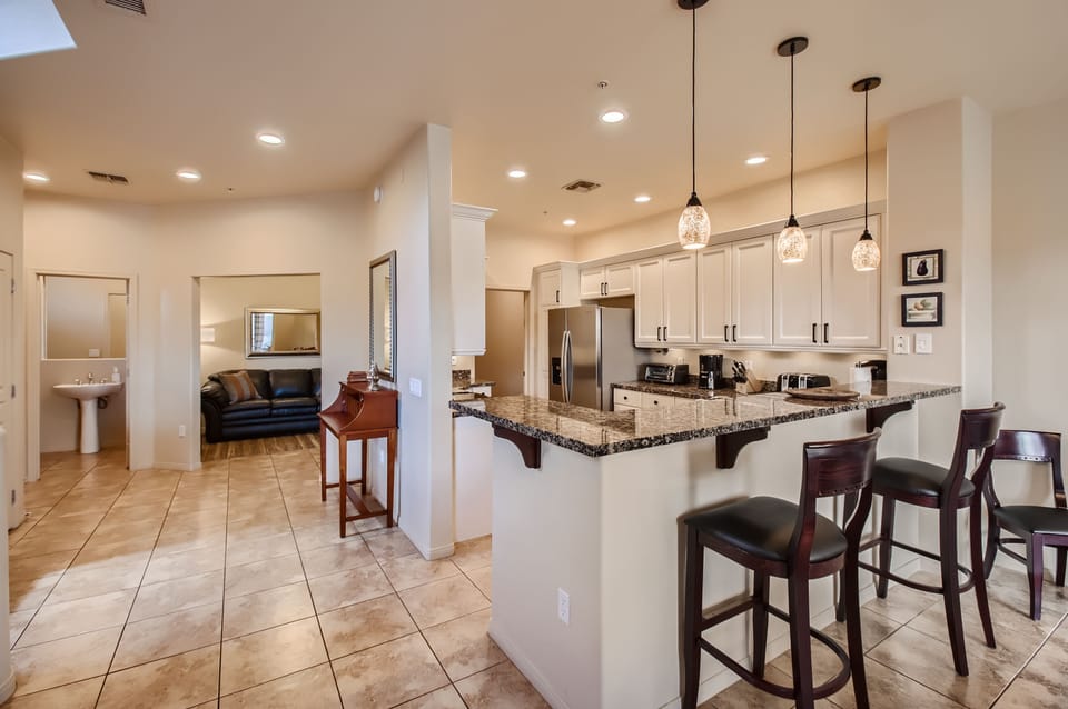 Kitchen breakfast counter and foyer, looking out to office/den. 