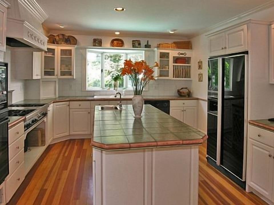 Kitchen  with Wolfe six burner cook top, Bosch oven and Italian tile countertops