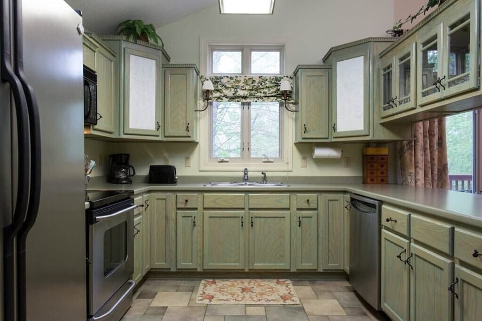 Just past the door is the fully equipped kitchen complete with stainless steel appliances including a side-by-side refrigerator.