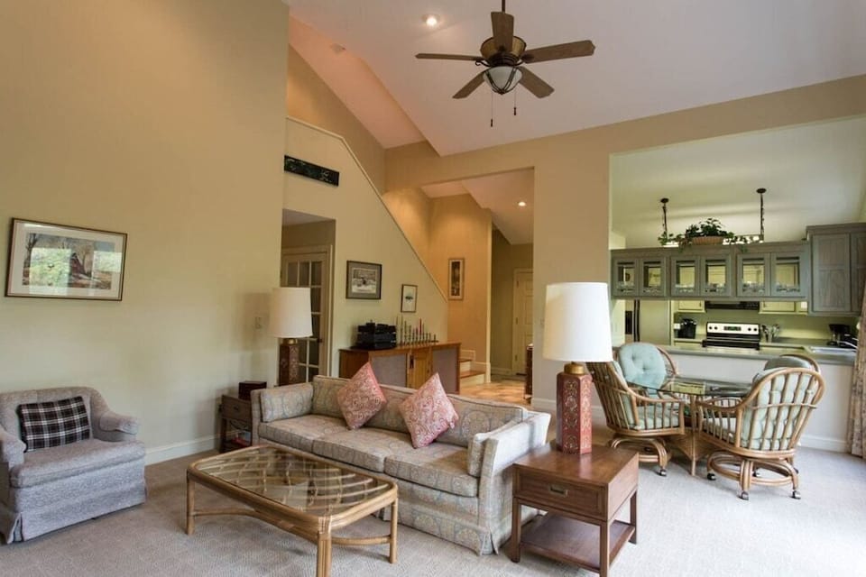 Past the dining area is the living area with comfortable furniture and a TV.