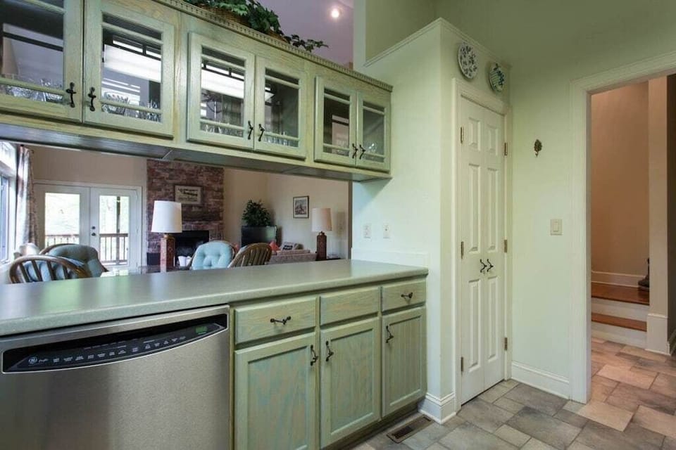 While it is not completely open to the dining and living areas, there is an open space between the counter and glass-door overhead cabinets.