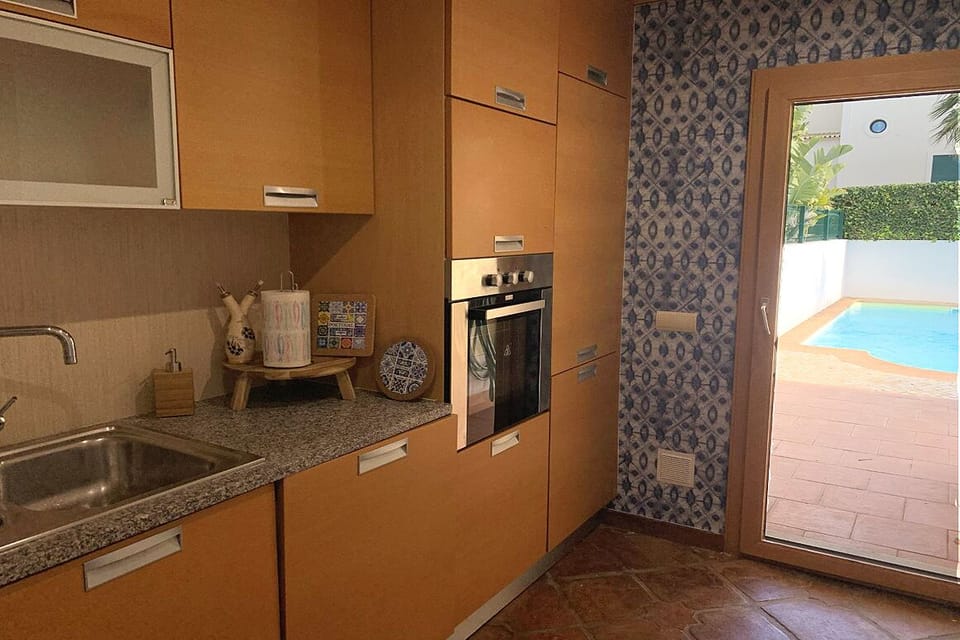Kitchen has door to the patio and pool area