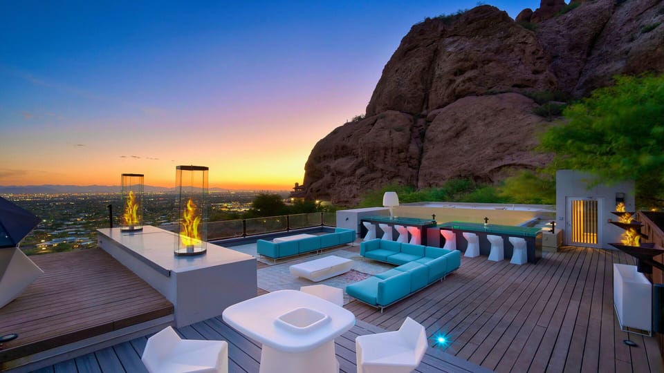 Luxury rooftop lounging w/ bar seating and unique fire features