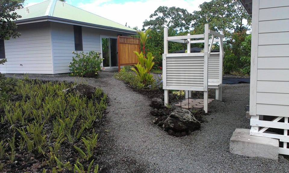 Your path from parking area to the cottage.  Outdoor shower with bench at right.