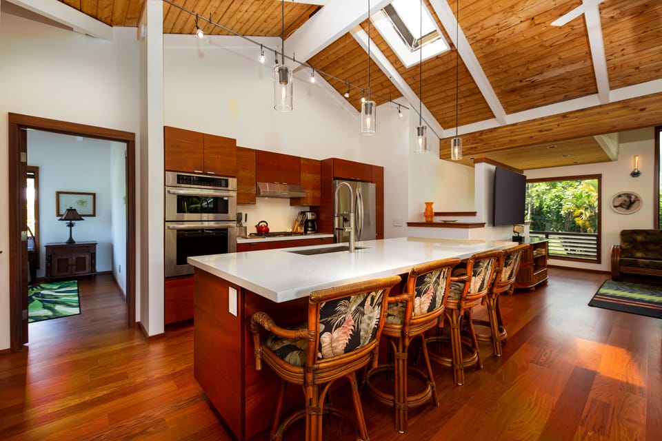 Kitchen - Bar seating for four, high mount faucet, side by side refrigerator, microwave and wall oven.