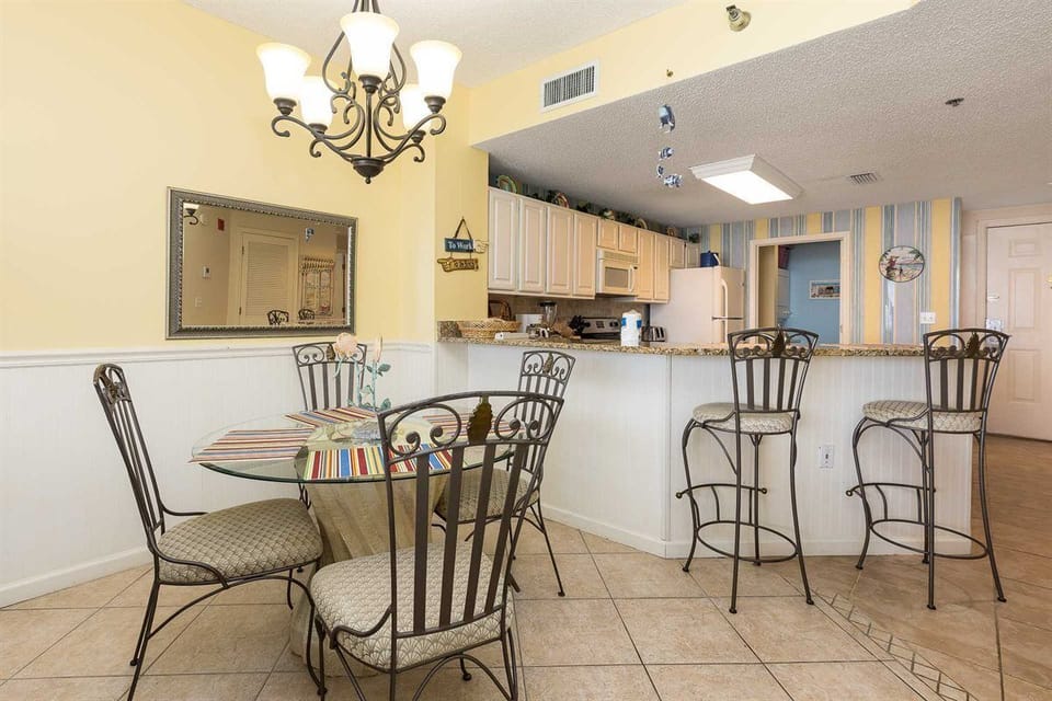 Dining table w kitchen in background