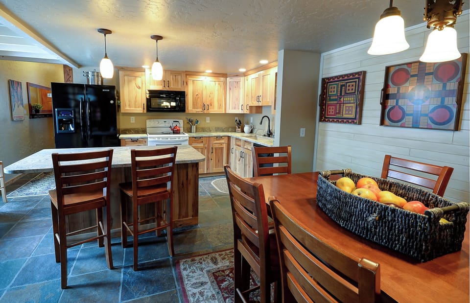Kitchen level includes a dining area with comfortable seating for 10.
