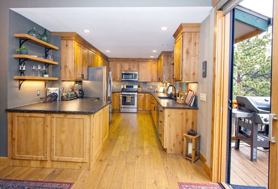 Kitchen with gas range, dishwasher, microwve, coffee pot, and fridge