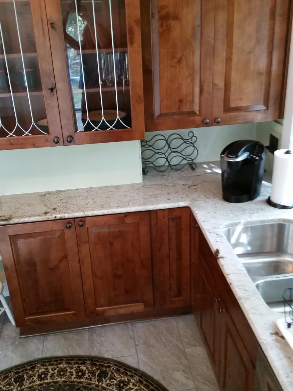 View of kitchen cabinets, granite countertops, Keurig coffee maker
