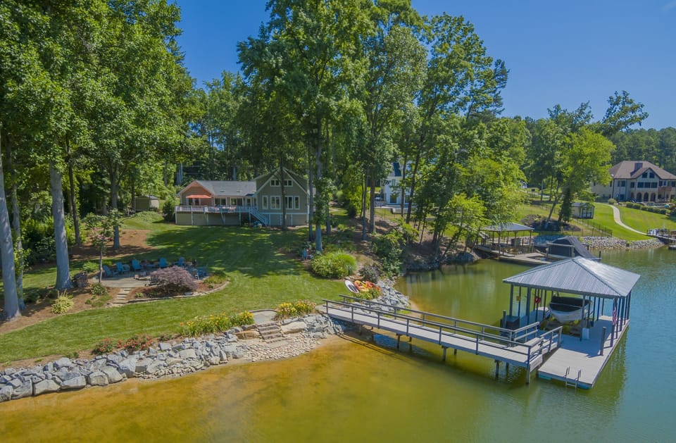 Aerial lake view of  backyard, dock and shoreline