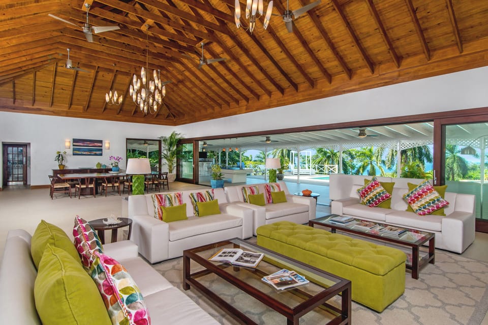 Great room viewed from hallway out to covered terrace, bar, pool and ocean