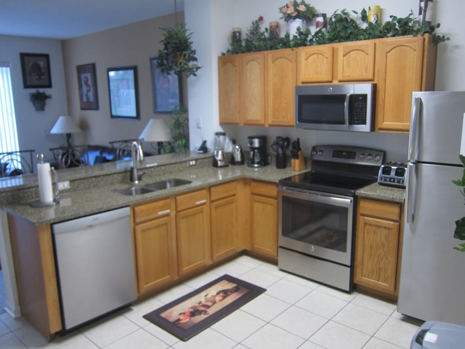 Fully equipped kitchen with quartz counter top and bar.