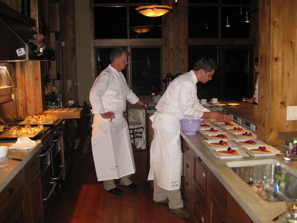 Plating dinner in open kitchen for guests