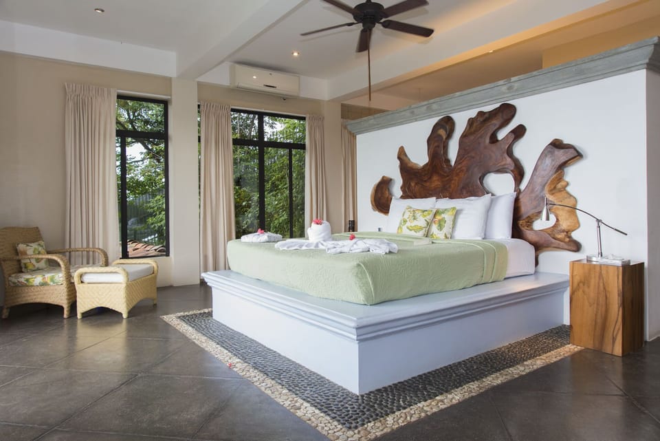 The large master bedroom with ocean view and a beautiful king bed