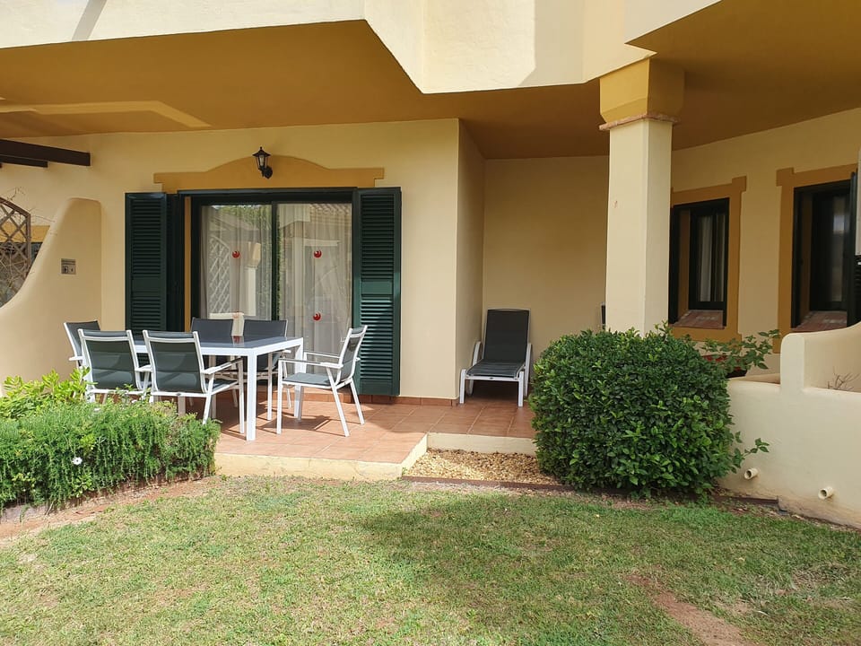 Patio area off master bedroom, access to pool and garden
