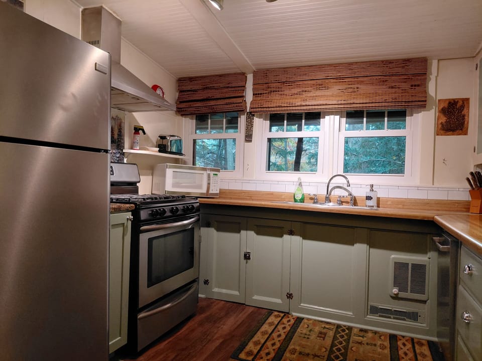 Charming kitchen is equipt with fill size appliances