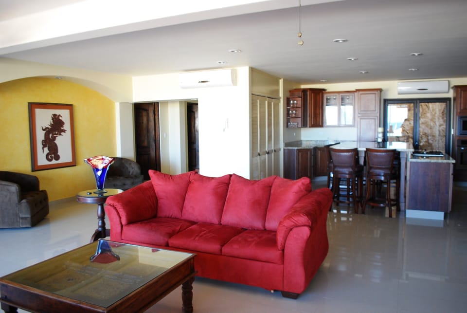 The living room features two sofa beds and room-darkening custom drapes. 