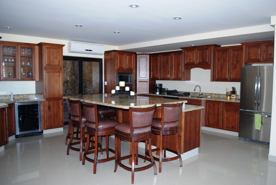 Kitchen has an island that seats up to 8, granite countertops, Thomasville cabinets and stainless steel appliances. 