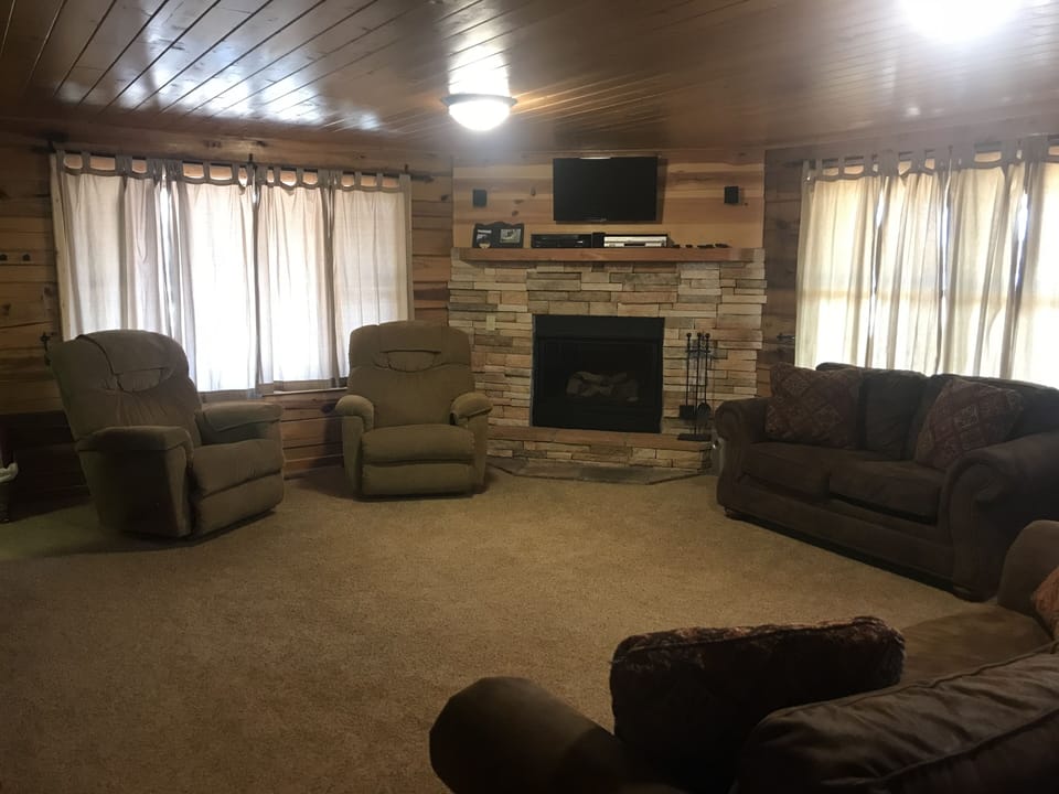 Large Living area with Gas fireplace, 2 recliners, sofa, and loveseat