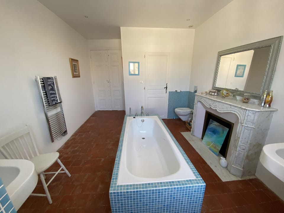 Family Bathroom 1 with two sinks, large bath, loo and marble fireplace 