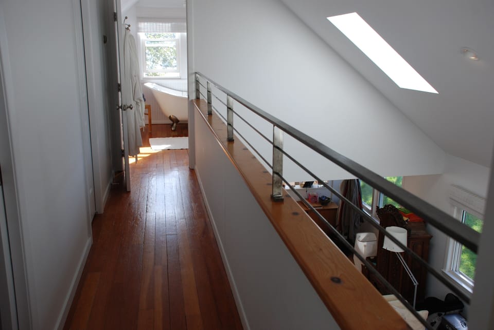 Aisle leading from 3 kids' rooms and master bedroom to bathroom upstairs