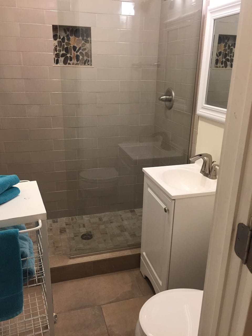 Contemporary style bath all tile, stone work  with euro glass