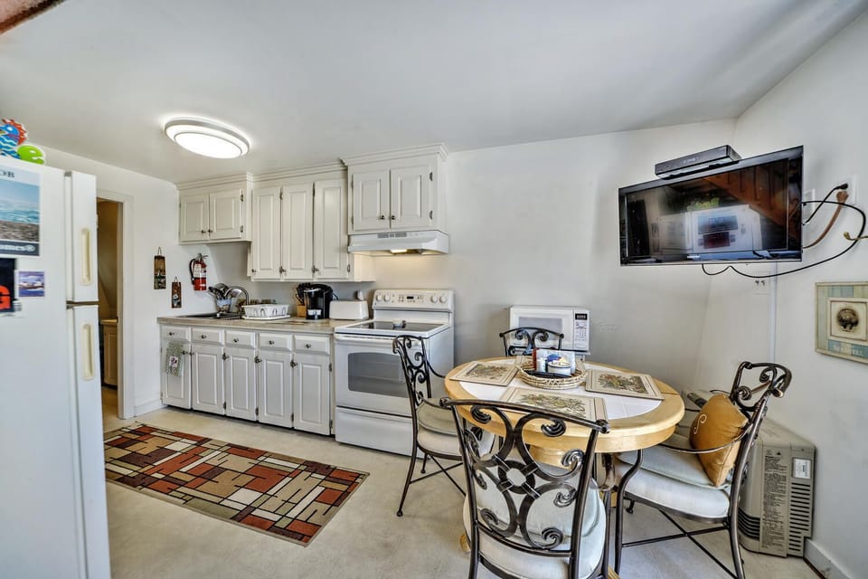 Dining room table in dinette area has extension if required.