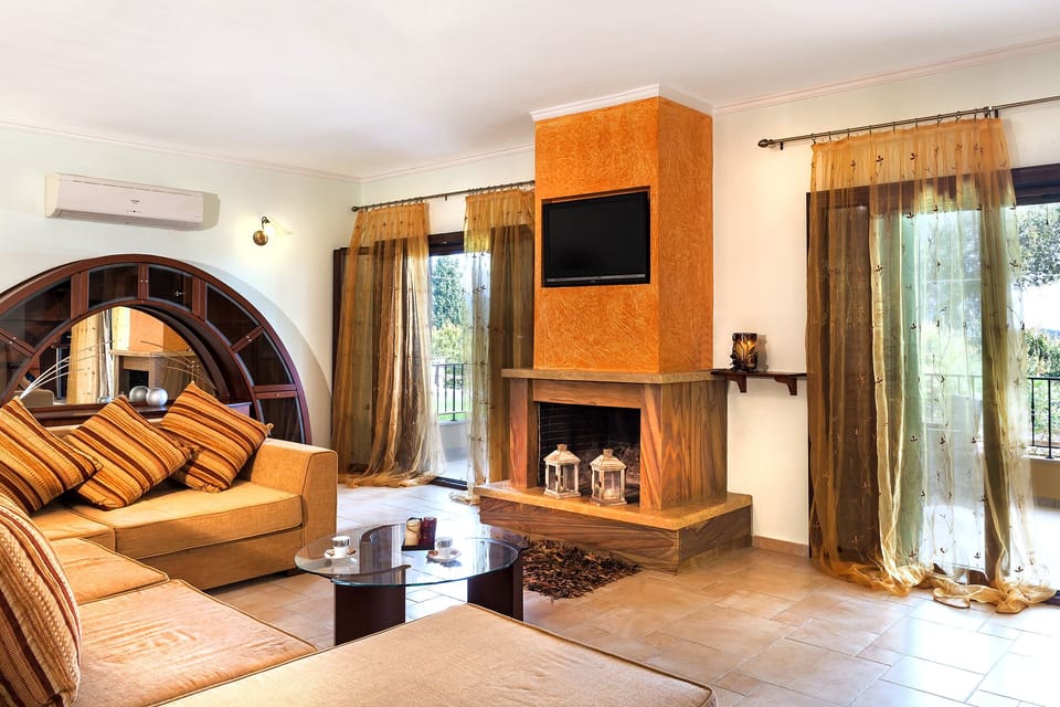 Living room, ground floor veranda, fireplace and TV set