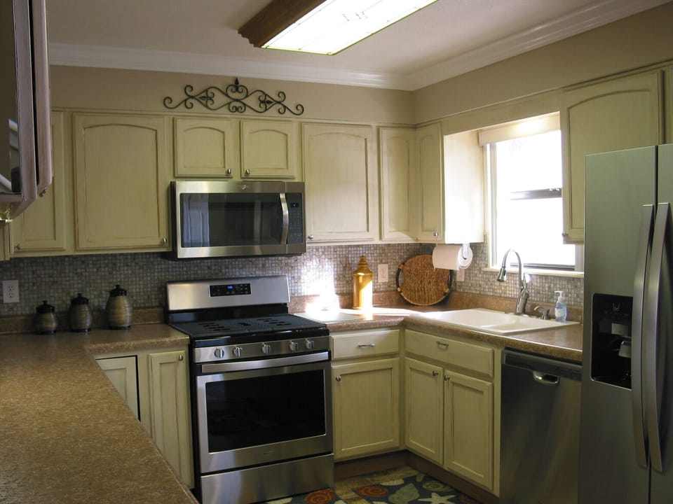 New stainless appliances. Cream glazed cabinets and tile back splash. 