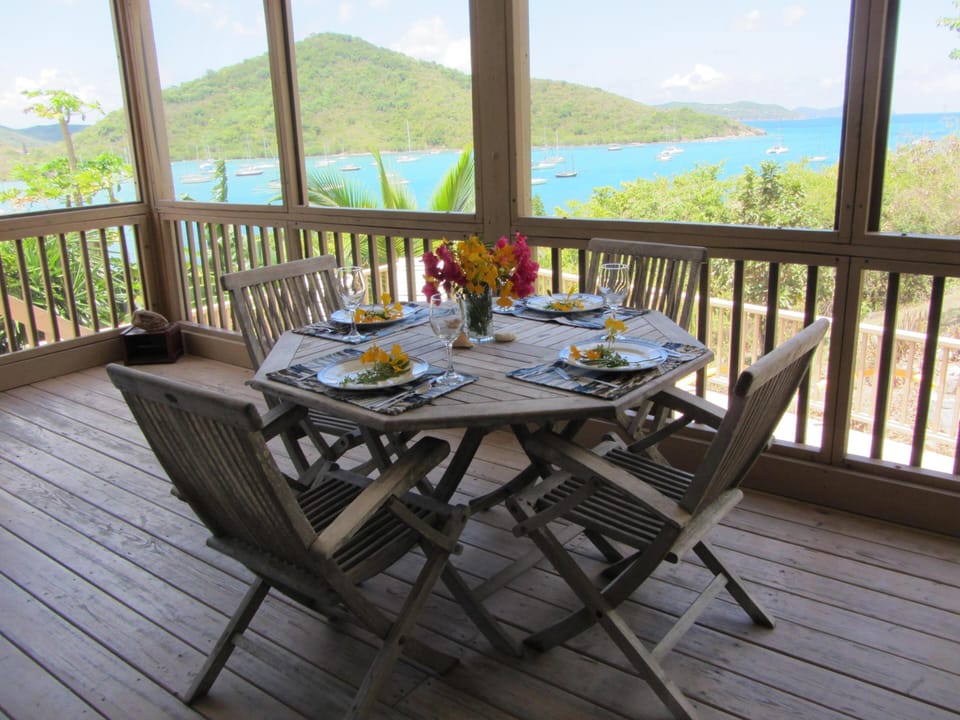 Dine over looking beautiful Coral Bay in a screened in deck area
