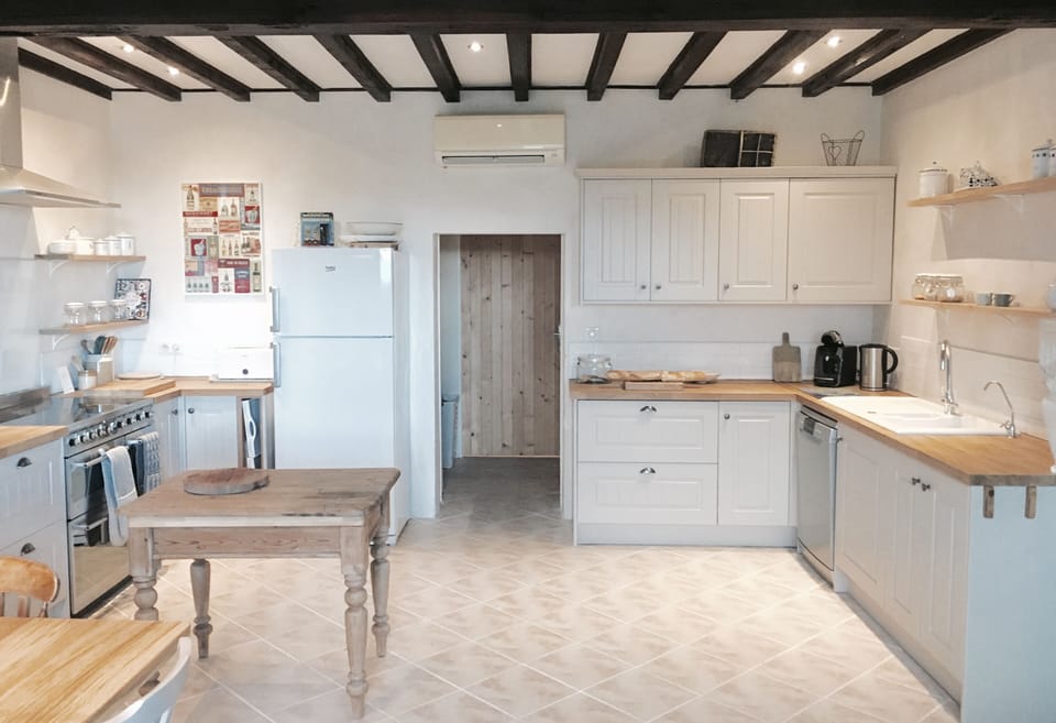 new kitchen layout with stunning units, bespoke shelving and SMEG cooker