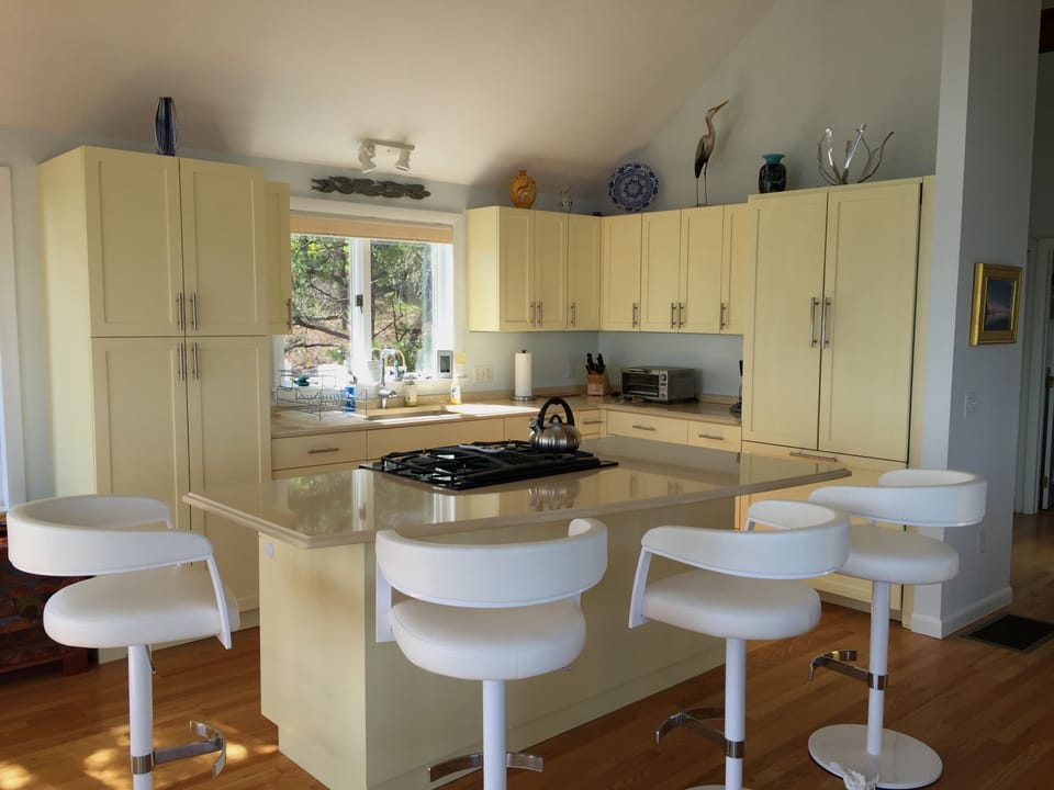 Kitchen with island and dining stools.