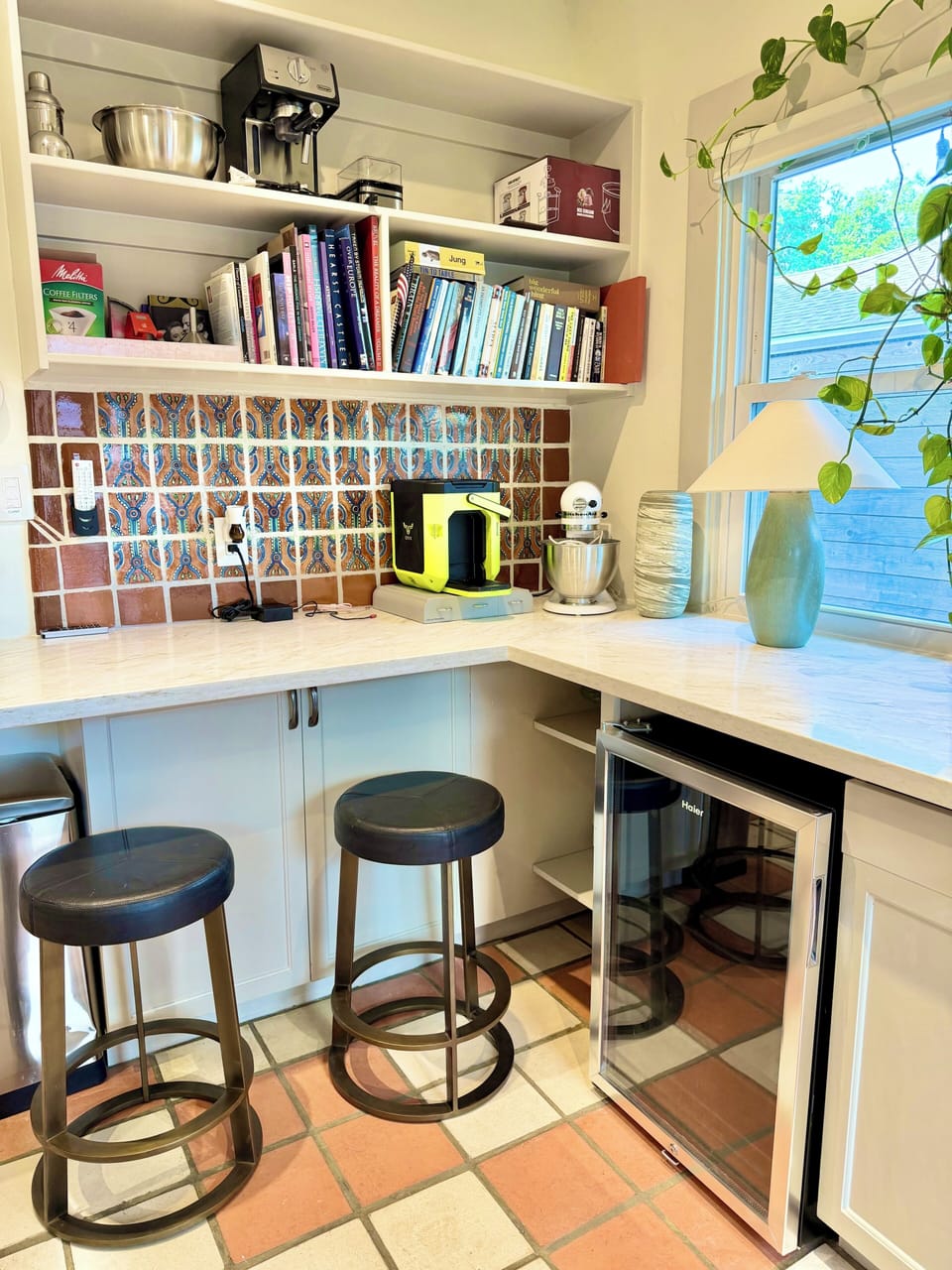 Bar seating with CB2 Stools and mini fridge in kitchen
