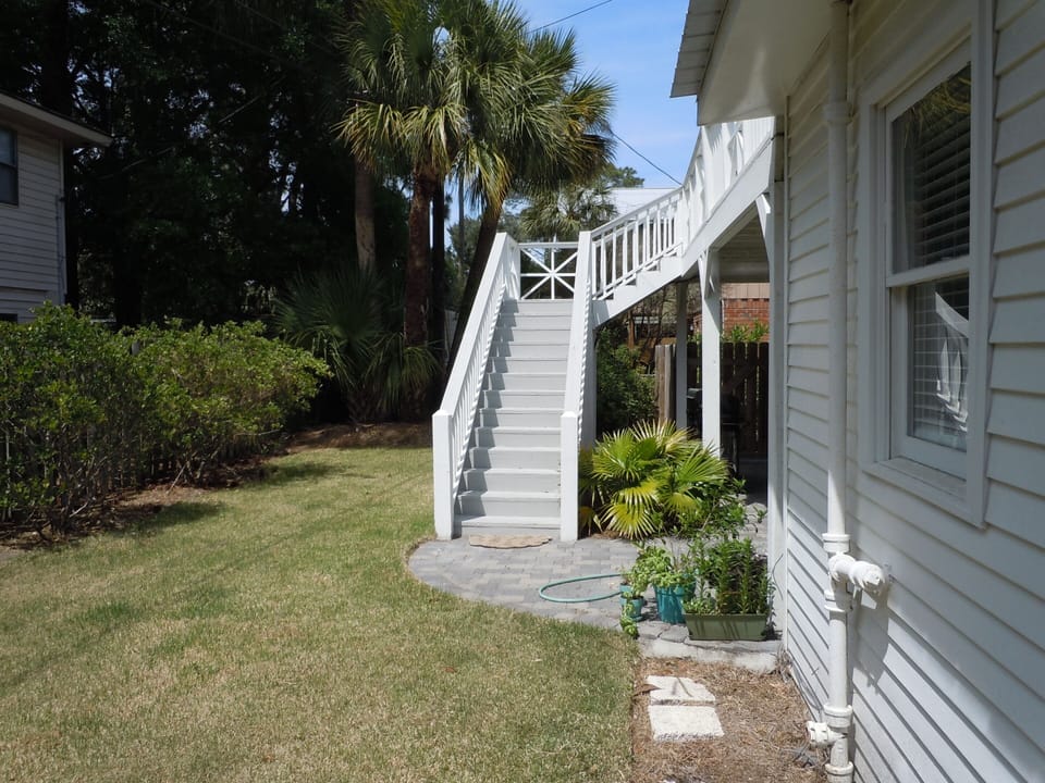 Under the back stair case is the outdoor shower equipped with hot and cold water.
